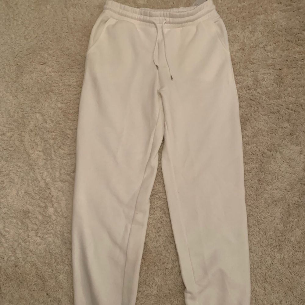 white sweatpants with cinched material on waist and bottoms- size M
